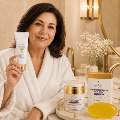 Woman holding Skin by Flora SPF 90 tinted sunscreen with face cream and face soap