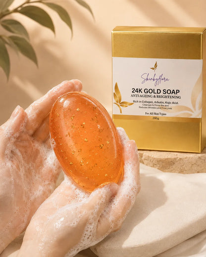 Skin by Flora 24K Gold Soap oval pinky-orange bar with gold particles in lathered hands