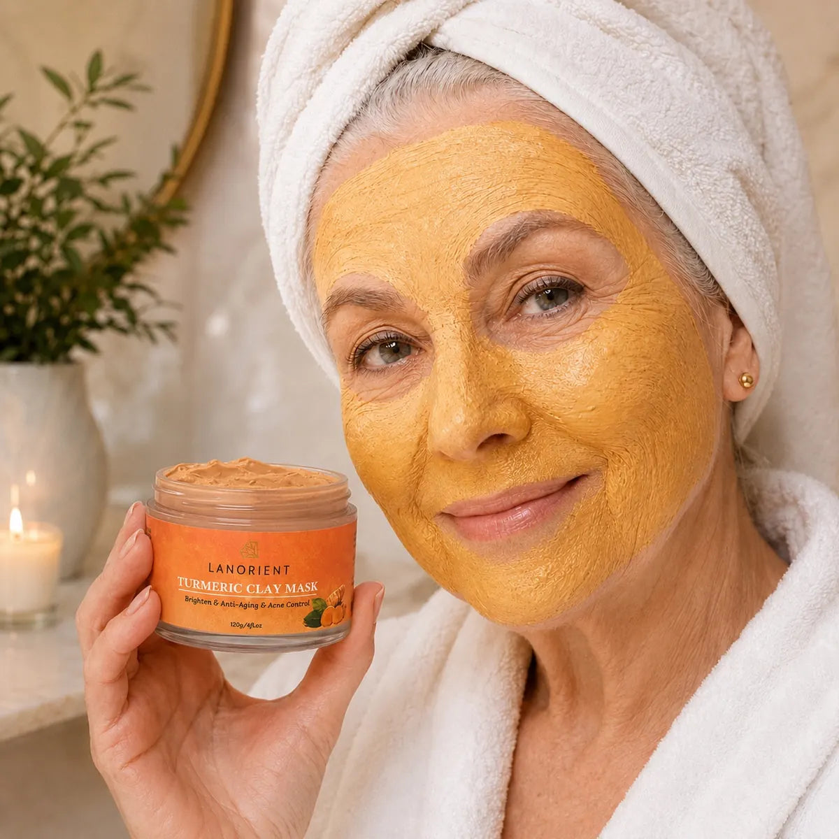 Mature woman wearing Turmeric Clay Face Mask and holding the open jar
